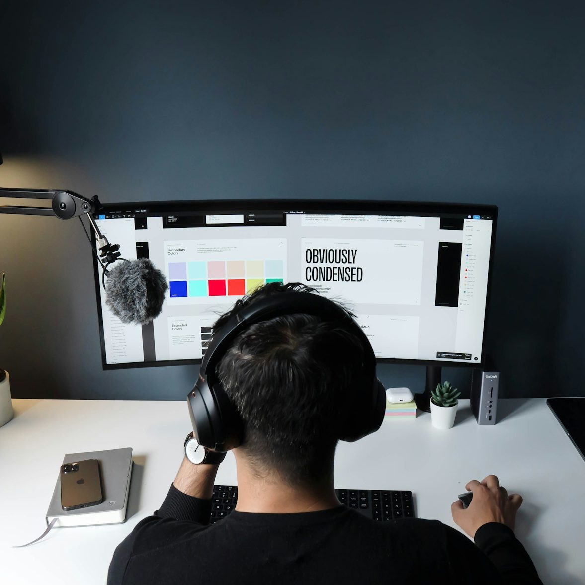 Designer working at a screen with a brand identity system.