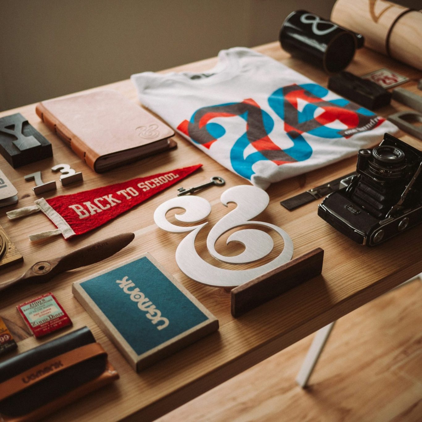 Creative brand assets arranged on a wooden worktable.